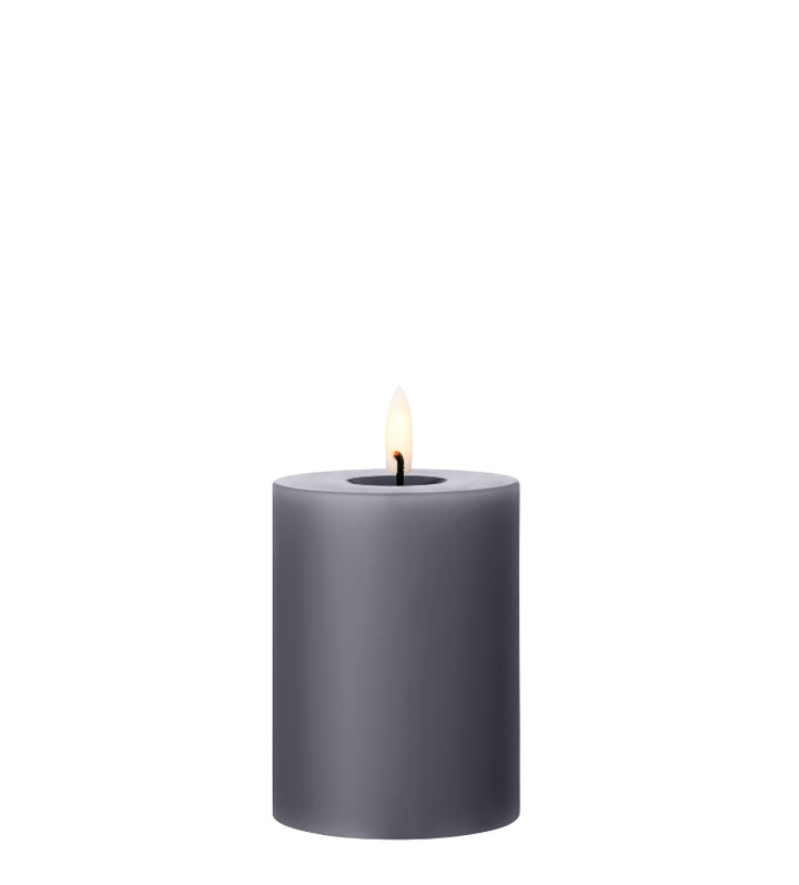 Ester & Erik LED pillar candle in gray with a lifelike glow, perfect for elegant decor and special occasions.