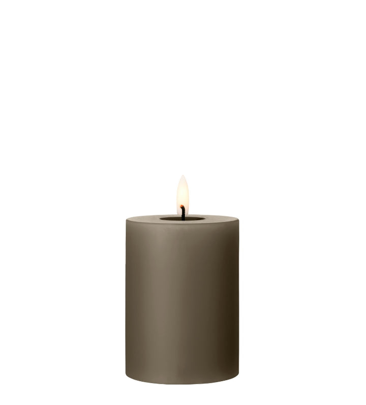 Ester & Erik LED pillar candle in earthy green with lifelike glow, perfect for events and home décor.