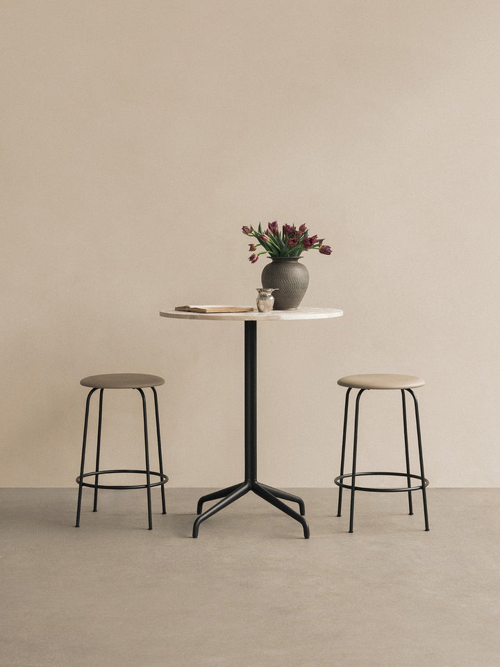 Afteroom Counter Stool, Upholstered Seat by Audo Copenhagen - Effortlessly blend style and comfort with the Afteroom Counter Stool. Crafted with clean lines and a sturdy steel base, this stool adds durability to any space. Customize the upholstery and cho