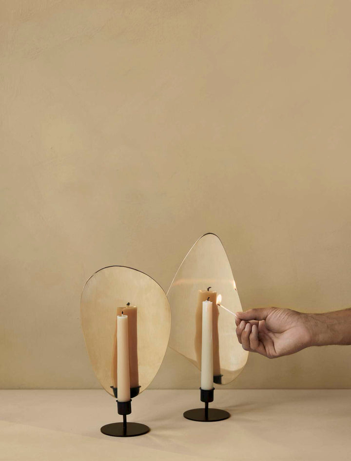 Flambeau Table Candle Holder by Audo Copenhagen - Inspired by French modernist lighting fixtures and designed to resemble a flickering flame, Flambeau is a sculptural design with playful presence. The metal backplate magnifies and reflects candlelight to