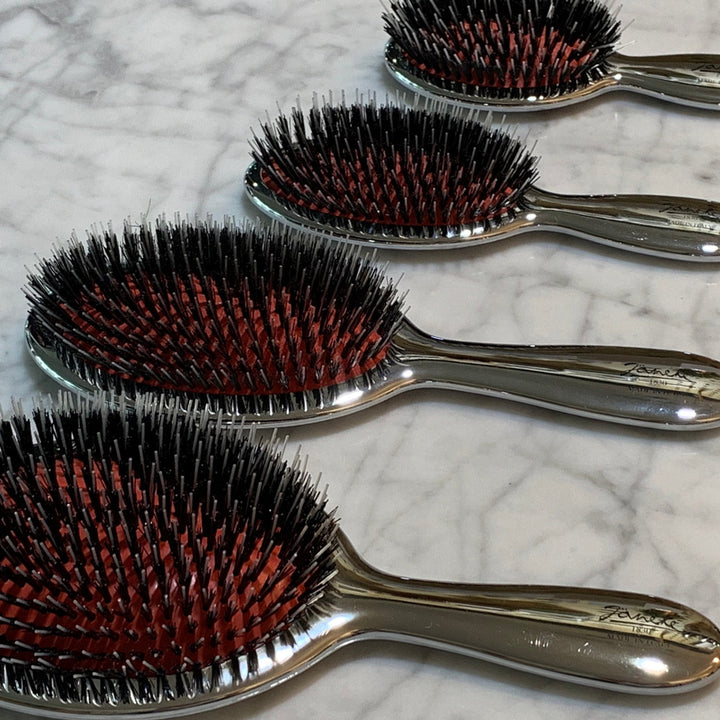 Janeke Silver Nylon/Boar Bristle Hairbrush - 3 Sizes This hairbrush combines both shine and detangling abilities with its unique blend of nylon and boar bristles. It effectively distributes the natural oils from your scalp to the ends of your hair, while