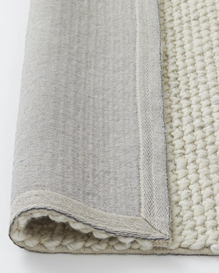 Emerson Seasalt - Luxurious Thick Rug Emerson Seasalt offers a soft, textured rug in a warm off-white tone, perfect for bedrooms and more with a durable cotton backing.