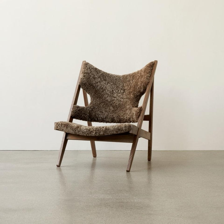 AUDO CPH Knitting Chair - Dark Oak & Sheepskin Shop the iconic AUDO CPH Knitting Lounge Chair, handcrafted in Sweden with luxe sheepskin for supreme comfort & elegance. by Audo Copenhagen Available at beon.com.au | Australian Stock