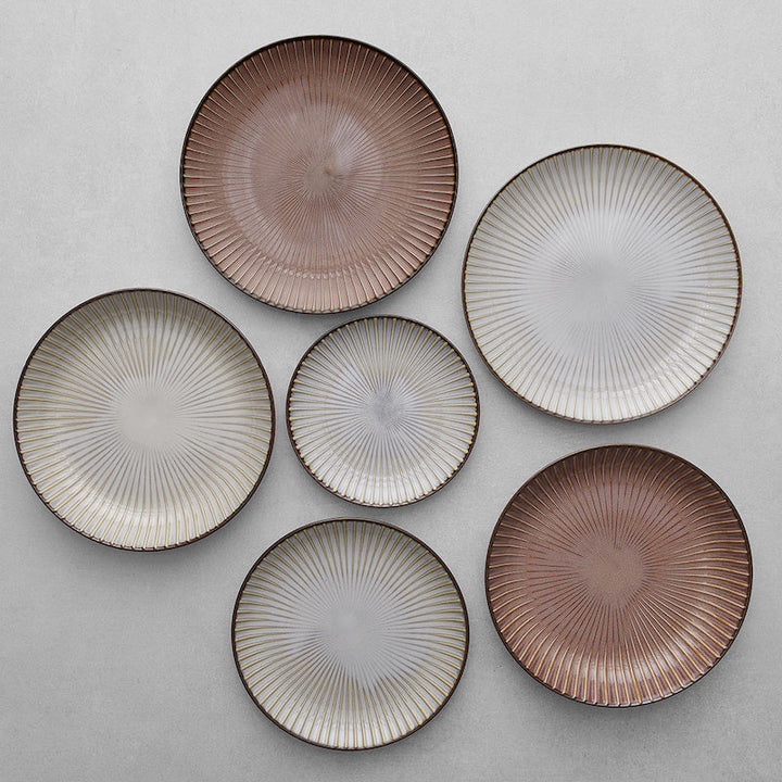 Set of six decorative plates with ribbed texture in earthy tones of brown and white.
