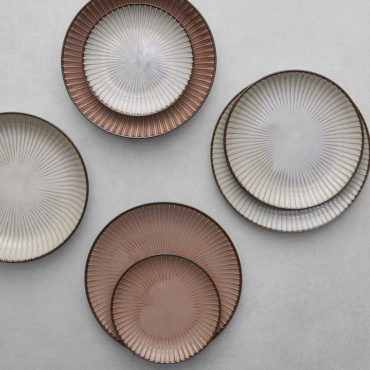 Set of four 21cm porcelain plates with ribbed design in warm hues and gold accents, perfect for elegant dining.