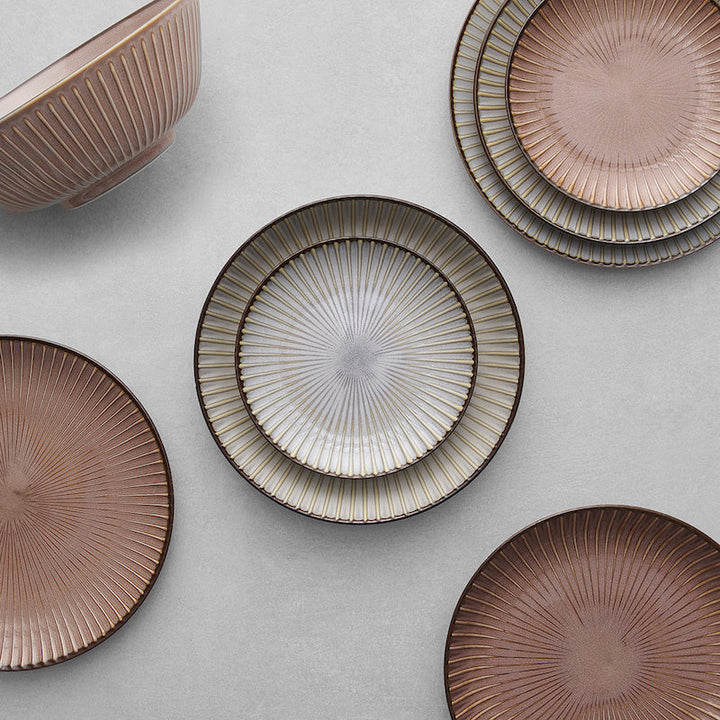 Elegant Mino ware porcelain bowls and plates with ribbed design and earthy color palette.