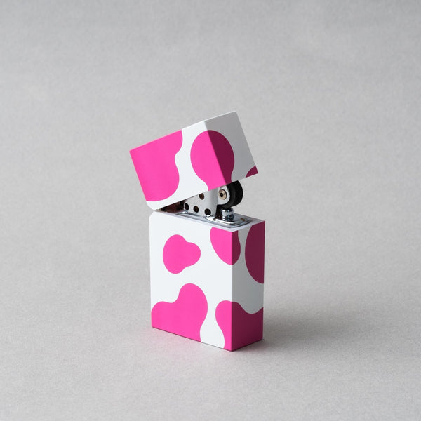 Tsubota Pearl Hard Edge Cow Pink petrol lighter with playful cow pattern design.
