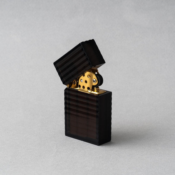 Tsubota Pearl Latitude Black petrol lighter with ridged casing and gold interior, handcrafted in Tokyo.
