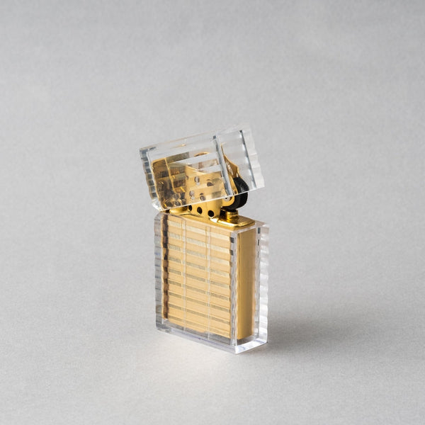 TSUBOTA PEARL Latitude Clear Gold petrol lighter showcasing handcrafted artistry and diamond-cut design.