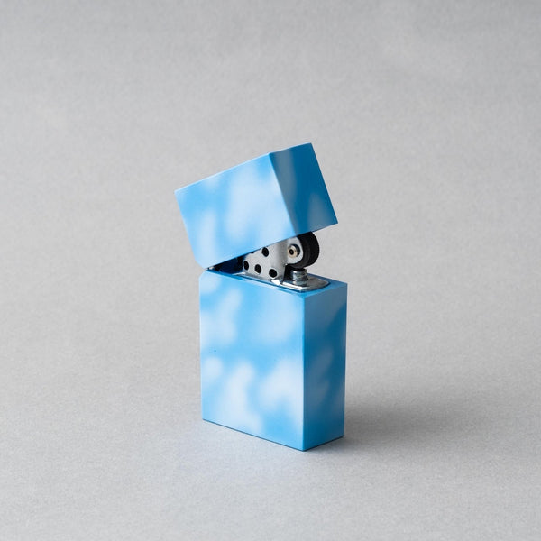 Handcrafted Tsubota Pearl Hard Edge Marble Sky petrol lighter in blue with cloud-like pattern.