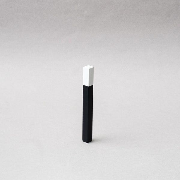 TSUBOTA PEARL Queue Matte Black and White Petrol Lighter showcased on a gray background, emphasizing its sleek design.