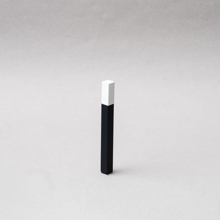 TSUBOTA PEARL Queue Matte Black and White Petrol Lighter showcased on a gray background, emphasizing its sleek design.