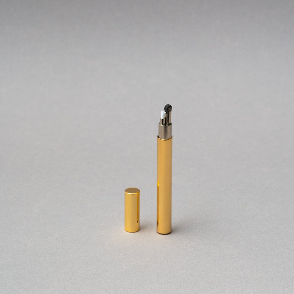 Elegant Tsubota Pearl Sigaretta gold petrol lighter with cap, showcasing artisan craftsmanship from Tokyo.