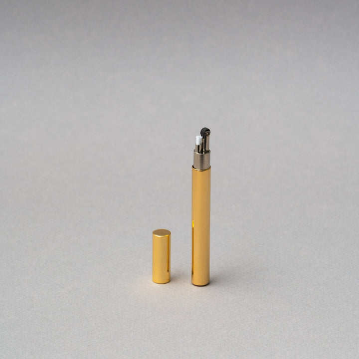 Elegant Tsubota Pearl Sigaretta gold petrol lighter with cap, showcasing artisan craftsmanship from Tokyo.