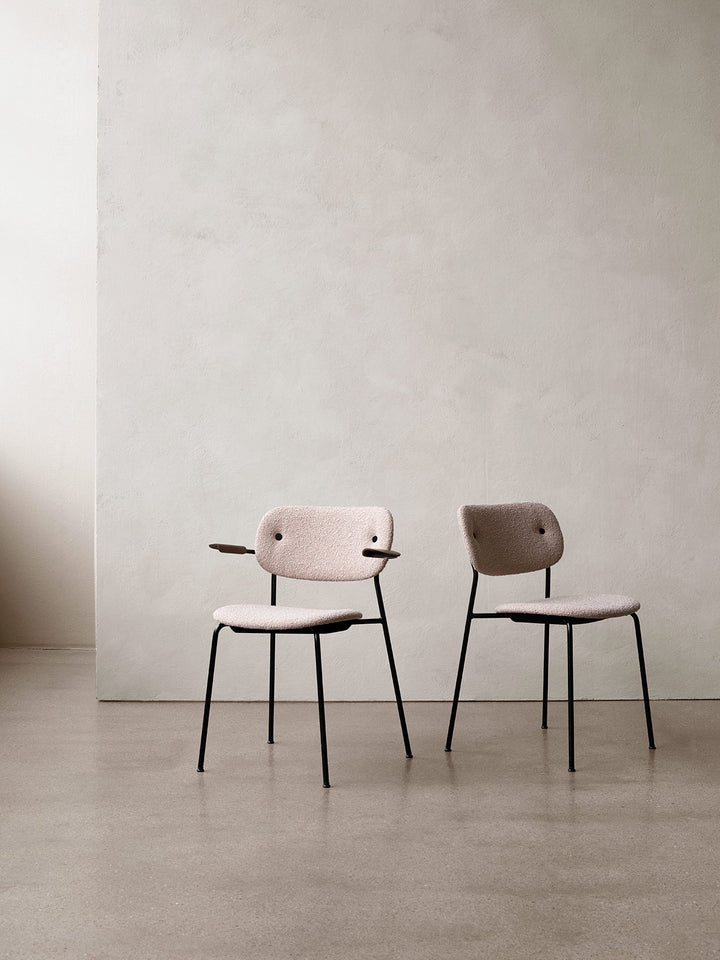 Co Dining Chair, fully upholstered with armrest, Black by Audo Copenhagen - The Co Chair Collection pairs a lightweight, sleek profile with great seating comfort. Available with or without armrests in three wood versions, the versatile design of the fully