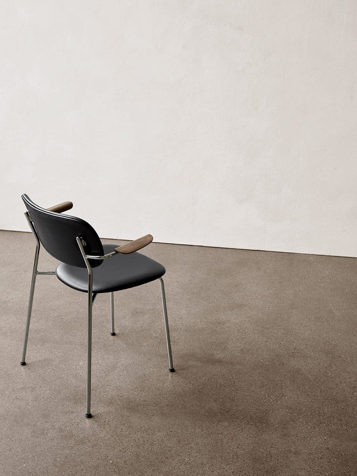 Co Dining Chair, fully upholstered with armrest, Chrome by Audo Copenhagen - The Co Chair Collection pairs a lightweight, sleek profile with great seating comfort. Available with or without armrests in three wood versions, the versatile design of the full