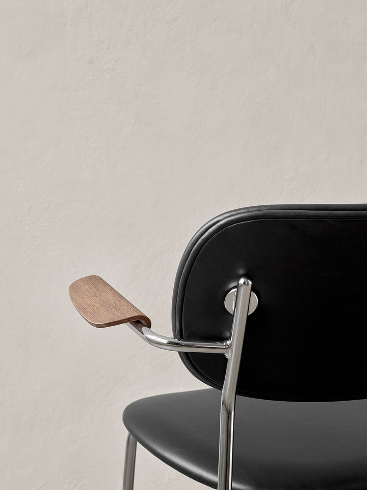 Co Dining Chair, fully upholstered with armrest, Chrome by Audo Copenhagen - The Co Chair Collection pairs a lightweight, sleek profile with great seating comfort. Available with or without armrests in three wood versions, the versatile design of the full