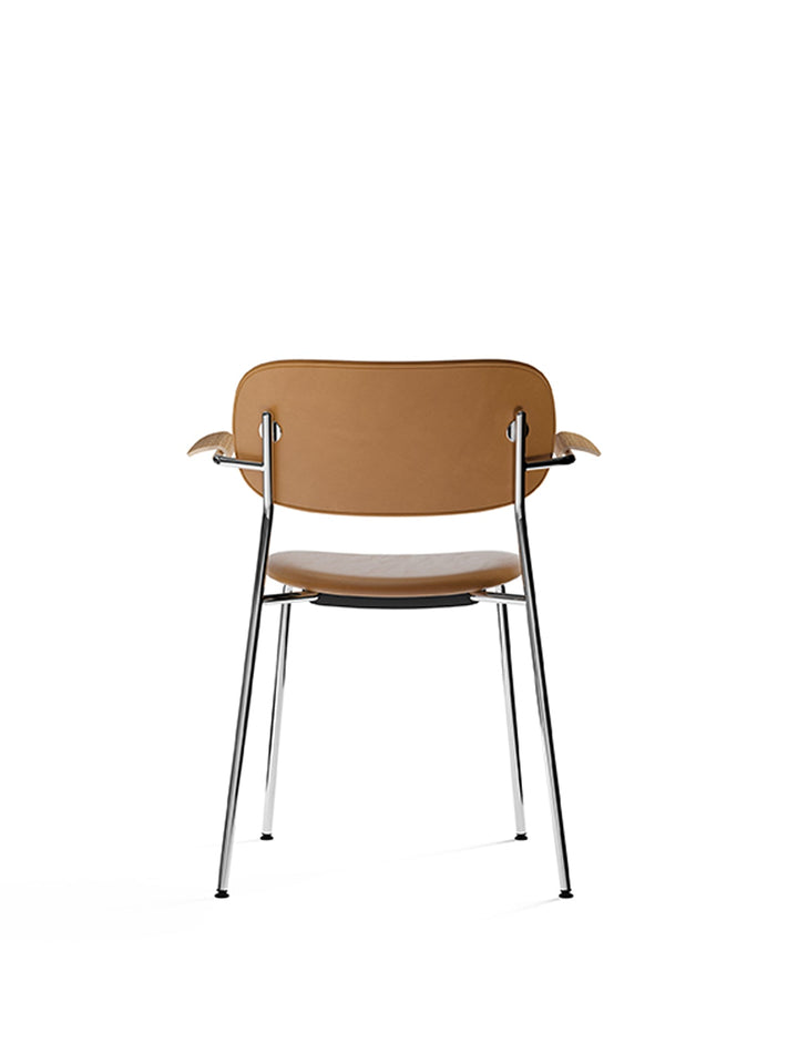 Co Dining Chair, fully upholstered with armrest, Chrome by Audo Copenhagen - The Co Chair Collection pairs a lightweight, sleek profile with great seating comfort. Available with or without armrests in three wood versions, the versatile design of the full