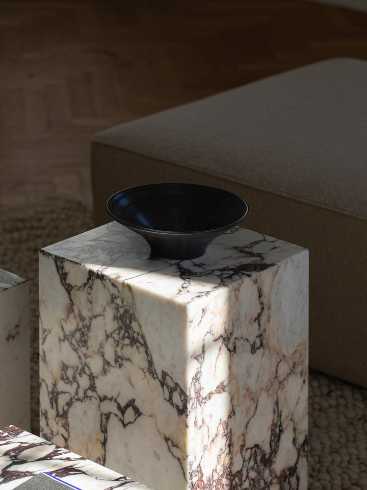 Plinth Tall by Audo Copenhagen - The Plinth Tall from the Plinth Collection boasts supreme craftsmanship and natural materials, including Calacatta Viola, Grey Kendzo, Nero Marquina, and White Carrera marble. With a symmetrical design, it serves as both a
