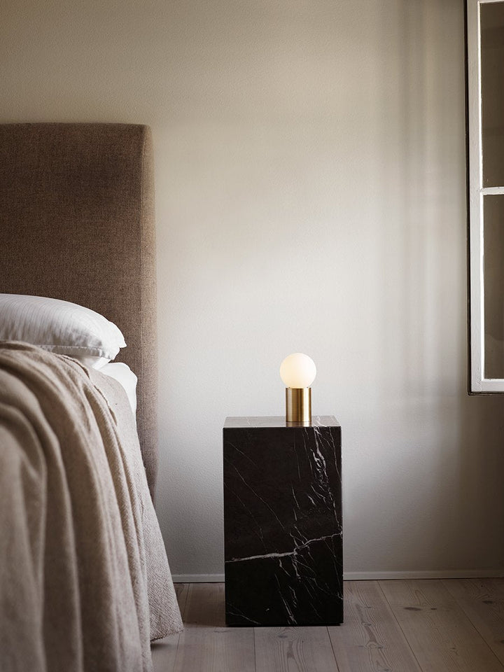 Plinth Tall by Audo Copenhagen - The Plinth Tall from the Plinth Collection boasts supreme craftsmanship and natural materials, including Calacatta Viola, Grey Kendzo, Nero Marquina, and White Carrera marble. With a symmetrical design, it serves as both a