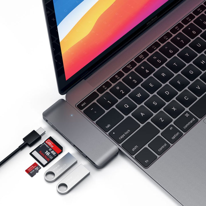 Satechi USB-C USB Pass Through Hub The Satechi Type-C Pass-Through USB Hub with USB-C Charging Port features a Type-C charging port, two USB 3.0 ports, an SD card slot and a Micro SD card slot. Use the Type-C Pass Through Hub to charge your Macbook as wel