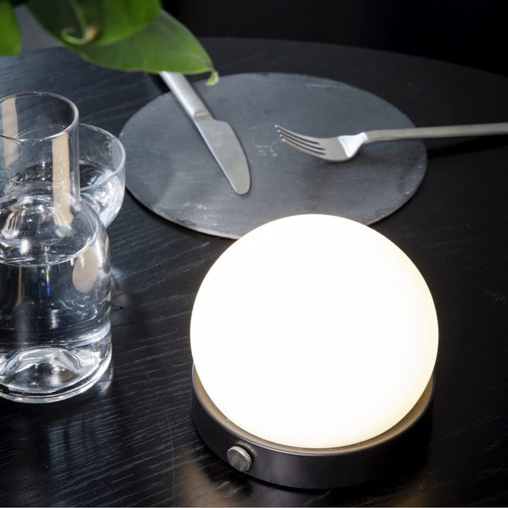 AUDO CPH (ex MENU) Carrie Lamp Portable + Rechargeable, Black by Audo Copenhagen - A minimalist innovation for freedom and flexibility, the Carrie Table Lamp, portable with a metal base and glass shade is unique for its multiple uses and mutability. Usefu