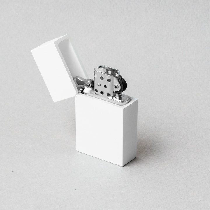 Tsubota Pearl hard edge white lighter with open lid, showcasing premium craftsmanship in Tokyo.