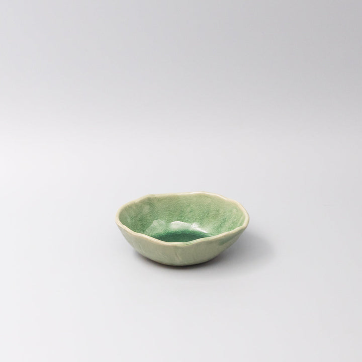 Oval 13.5cm bowl in jade green glaze, featuring an organic shape and fine crackle detailing, ideal for dips or sauces.