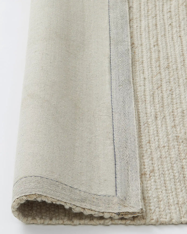 Andes Sandstorm - Hand-Woven Textured Floor Rug Discover the Andes Sandstorm rug, a stylish hand-woven floor piece perfect for coastal decor with warm cream tones and natural textures.