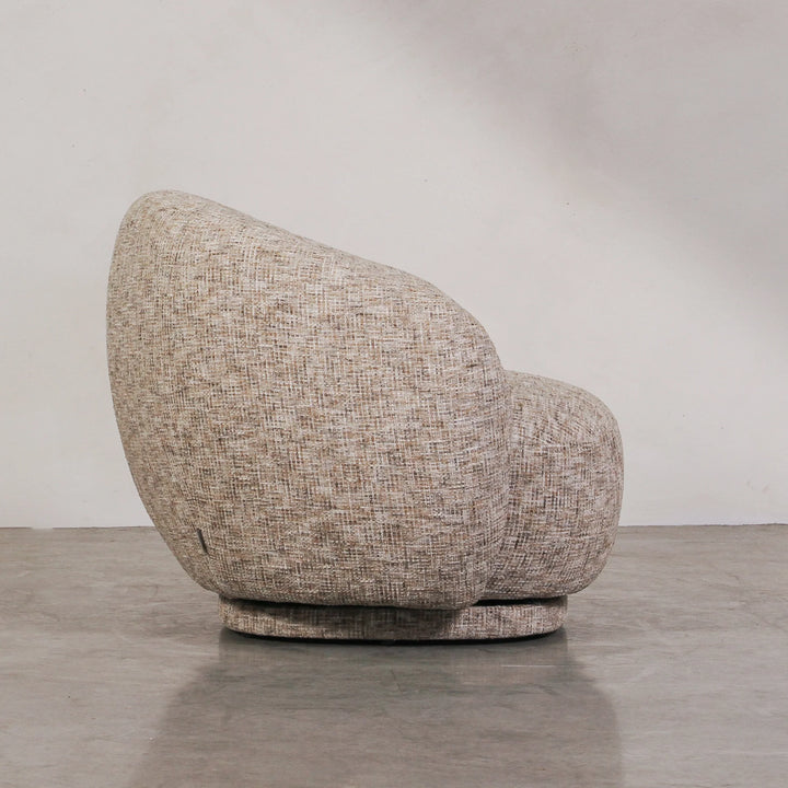 Aslan Occasional Chair Stone The Aslan Occasional Chair invites you to sink into plush comfort with its curved silhouette and soft, textured upholstery. This chair introduces a vibrant, multi-coloured fabric that adds bold personality while maintaining a