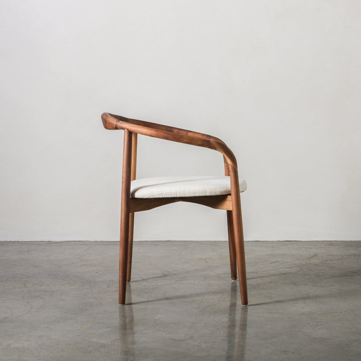 Essence Dining Chair Fabric/Walnut with curved walnut frame and fabric upholstery, showcasing elegant design and comfort.