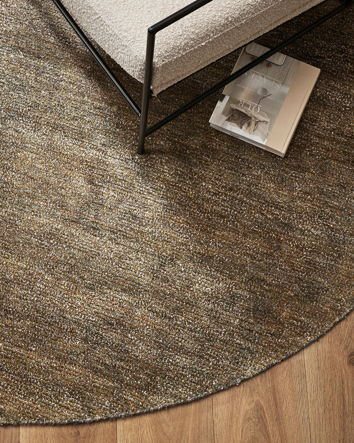 Anchorage Round Floor Rug Bring nature into your home with this handmade floor rug woven in natural fibres. A blend of bamboo silk and jute yarns gives the tufted surface subtle colour graduations, while the golden sand tone lays the foundation for a thou