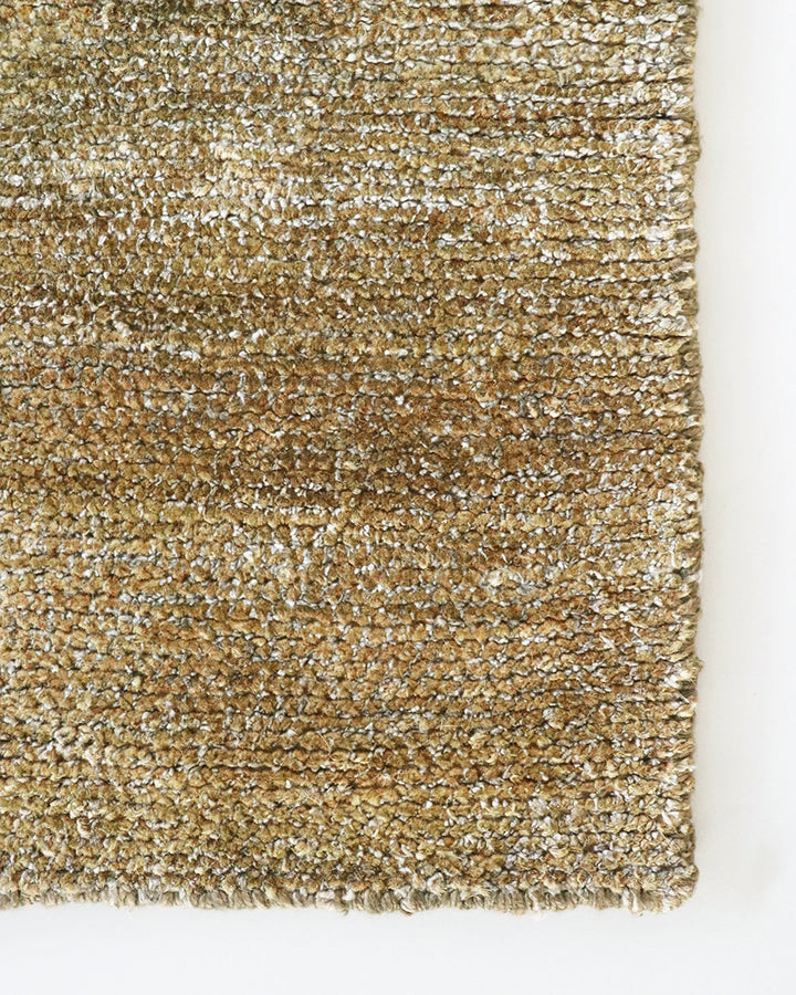 Anchorage Floor Rug Bring nature into your home with this handmade floor rug woven in natural fibres. A blend of bamboo silk and jute yarns gives the tufted surface subtle colour graduations, while the golden sand tone lays the foundation for a thoughtful