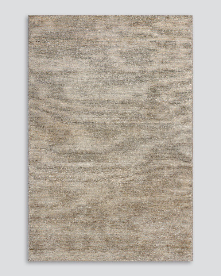 Anchorage Floor Rug Bring nature into your home with this handmade floor rug woven in natural fibres. A blend of bamboo silk and jute yarns gives the tufted surface subtle colour graduations, while the golden sand tone lays the foundation for a thoughtful