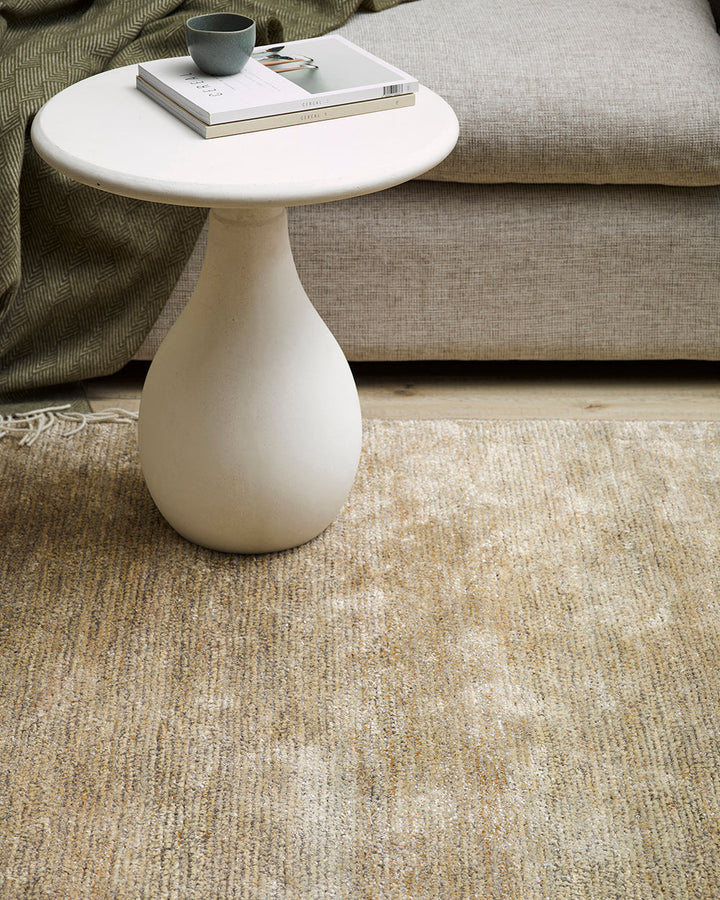 Anchorage Floor Rug Bring nature into your home with this handmade floor rug woven in natural fibres. A blend of bamboo silk and jute yarns gives the tufted surface subtle colour graduations, while the golden sand tone lays the foundation for a thoughtful