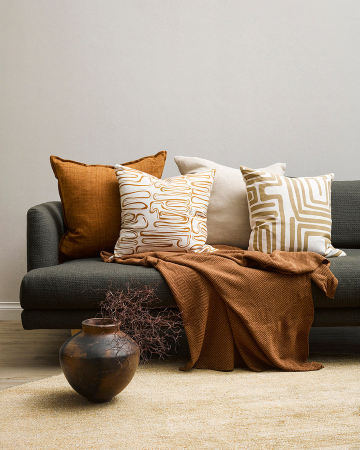 Anise Cushion Primal and abstract, the Anise makes a subtle, on-trend statement with organic hand-painted patterns. Warm tones of brass and ivory bring a sense of calm and serenity to spaces. Pair with sister cushion Chemin and core cushions Cassia Tobacc