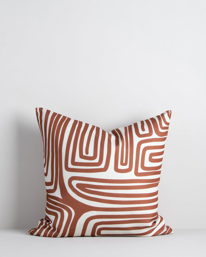 Ano Cushion Evoke a vibrant, global vibe with the hand-drawn design of our Ano cushion. Primal and abstract, this striking cushion makes a statement with a rich pecan toned design captured on an ivory base. Created from 100% polyester, the durable nature