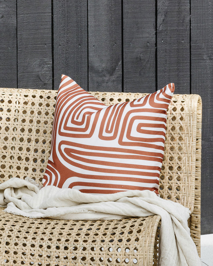 Ano Cushion Evoke a vibrant, global vibe with the hand-drawn design of our Ano cushion. Primal and abstract, this striking cushion makes a statement with a rich pecan toned design captured on an ivory base. Created from 100% polyester, the durable nature