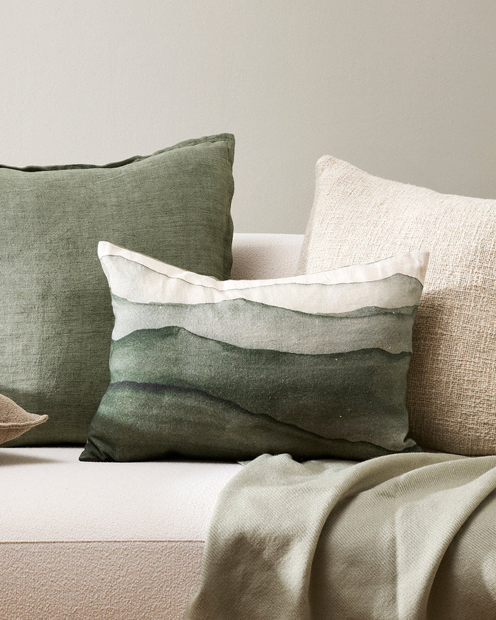 Aurelia Cushion Invite the landscape inside with the evocative hand-painted design of Aurelia. Topographical forms are captured in a serene colour palette that creates a sense of calm and promotes wellbeing. Pair with neutral, sage, and winter moss tones.