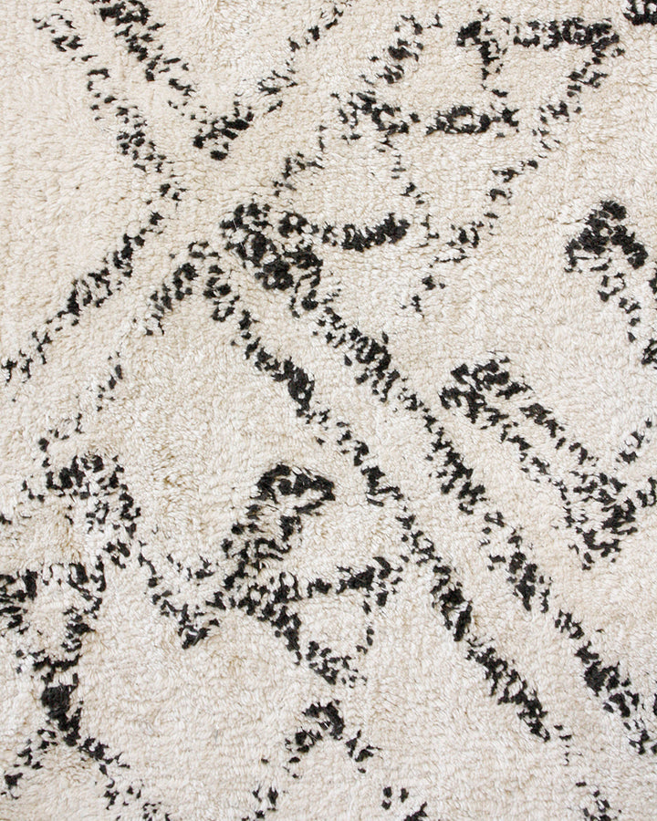 Awan Floor Rug Add a layer of comfort to your home with the soft 100% cotton tufting of the Awan. Featuring a shaggy pile and primitive patterning, the design is finished with a relaxed tassel edge. The casual aesthetic brings a well-travelled, welcoming