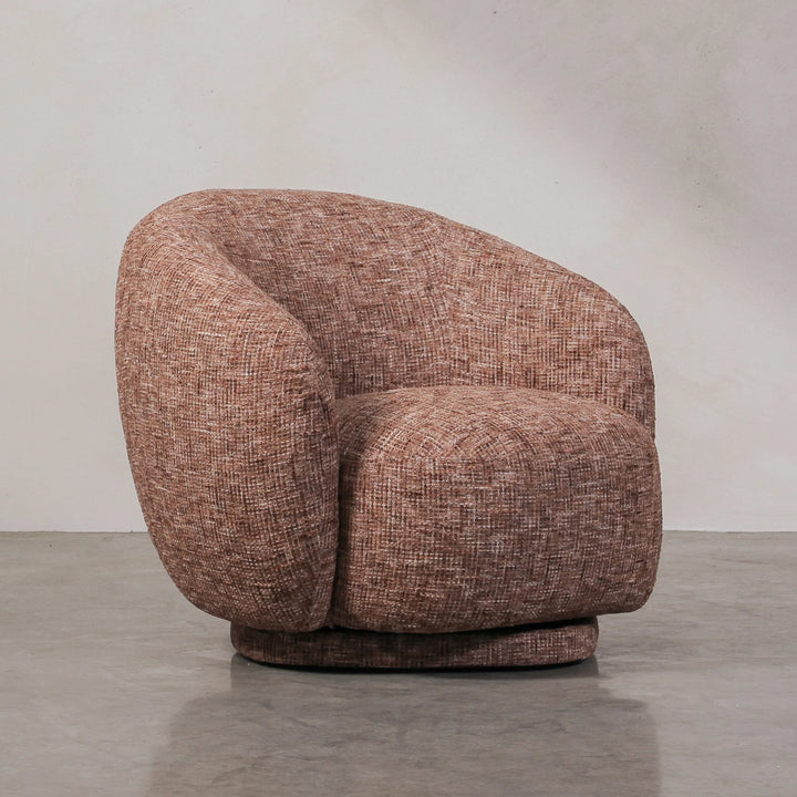 Aslan Occasional Chair Rust The Aslan Occasional Chair invites you to sink into plush comfort with its curved silhouette and soft, textured upholstery. This chair introduces a vibrant, multi-coloured fabric that adds bold personality while maintaining a r