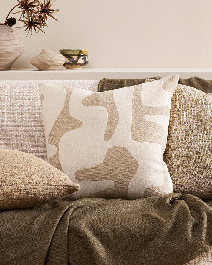 Bennett Cushion A simple tone-on-tone palette of biscuit and ecru brings a sense of harmony to interiors this season. Featuring an ensemble of abstract shapes in a jacquard woven design, the Bennettâ€™s soft tones and tapestry elements come together for a