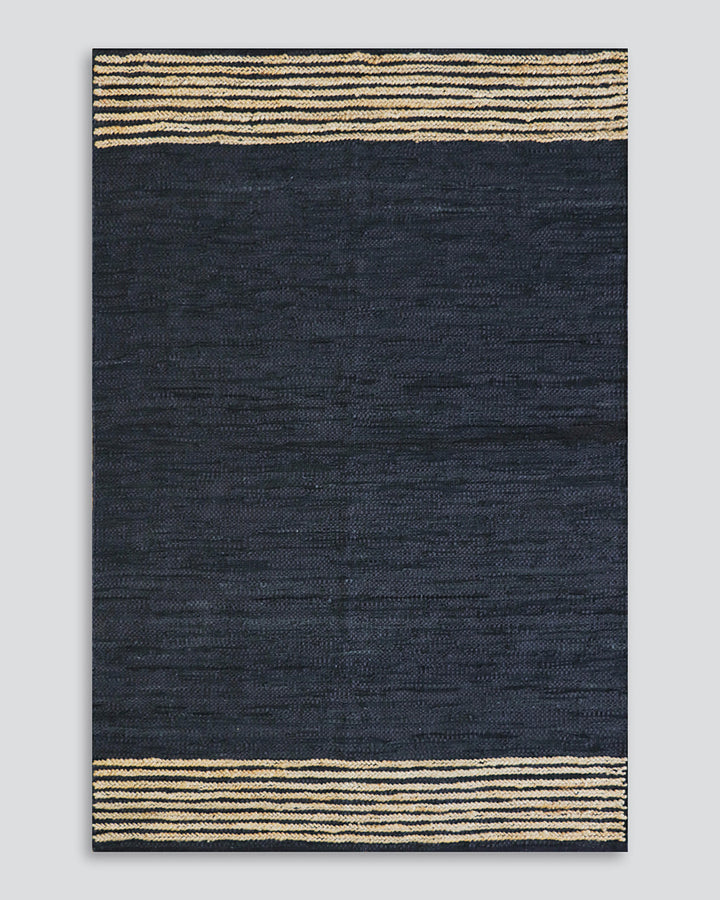 Bogota Floor Rug A contemporary take on leather, the Bogota creates visual interest through raw texture, depth of colour and simple design. Handwoven from soft strips of black leather, braided jute detailing is then applied on both ends to finish this pie