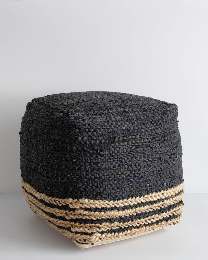 Bogota Ottoman Invite raw texture into your space with the distinctive beauty of our Bogota ottoman. Crafted from soft black leather with braided jute detailing, the hard-wearing nature and rustic texture of this piece creates a laid-back, artisan aesthet