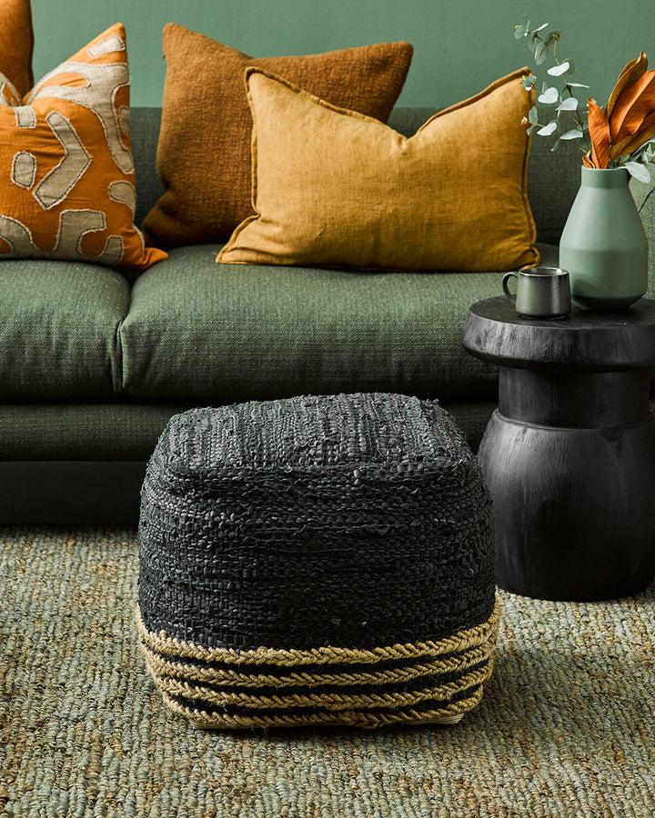 Bogota Ottoman Invite raw texture into your space with the distinctive beauty of our Bogota ottoman. Crafted from soft black leather with braided jute detailing, the hard-wearing nature and rustic texture of this piece creates a laid-back, artisan aesthet