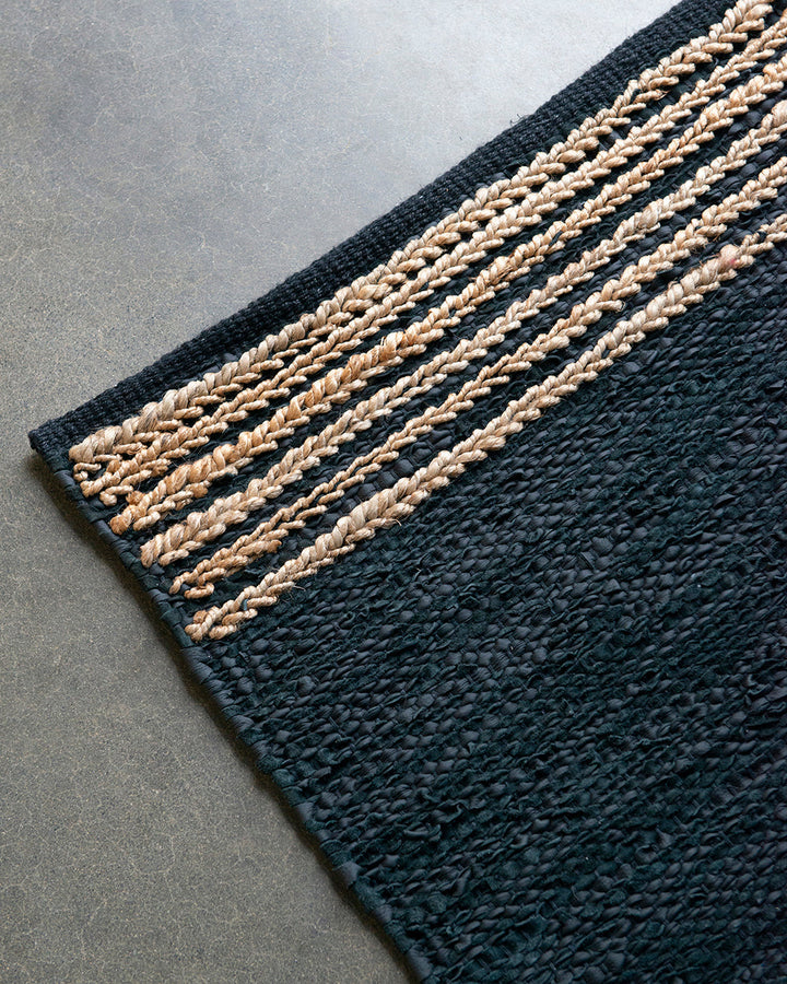 Bogota Floor Rug A contemporary take on leather, the Bogota creates visual interest through raw texture, depth of colour and simple design. Handwoven from soft strips of black leather, braided jute detailing is then applied on both ends to finish this pie