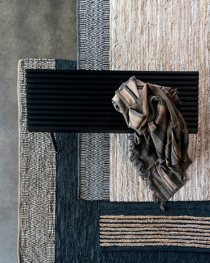 Bogota Floor Rug A contemporary take on leather, the Bogota creates visual interest through raw texture, depth of colour and simple design. Handwoven from soft strips of black leather, braided jute detailing is then applied on both ends to finish this pie