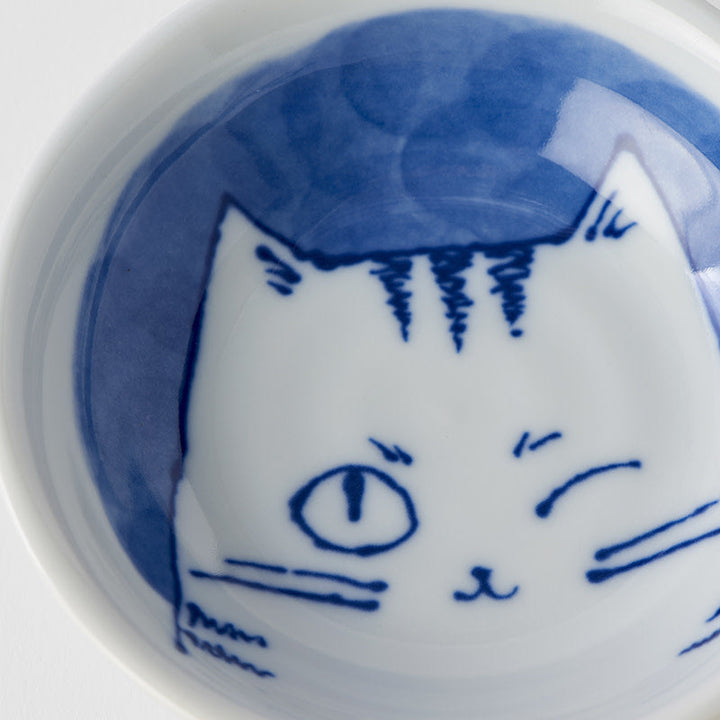 Bowl 10cm featuring a winking cat design in blue on white porcelain, perfect for snacks or decor.