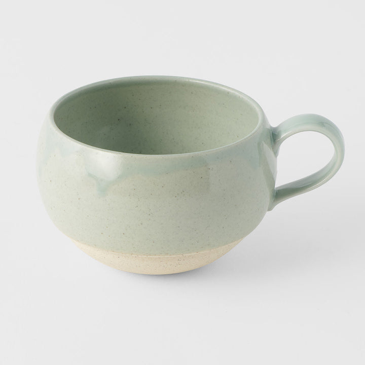 Elegant green ceramic mug with handle, perfect for tea or coffee, showcasing traditional craftsmanship.