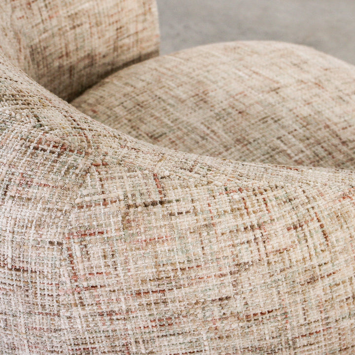 Aslan Occasional Chair Tawny The Aslan Occasional Chair invites you to sink into plush comfort with its curved silhouette and soft, textured upholstery. This chair introduces a vibrant, multi-coloured fabric that adds bold personality while maintaining a